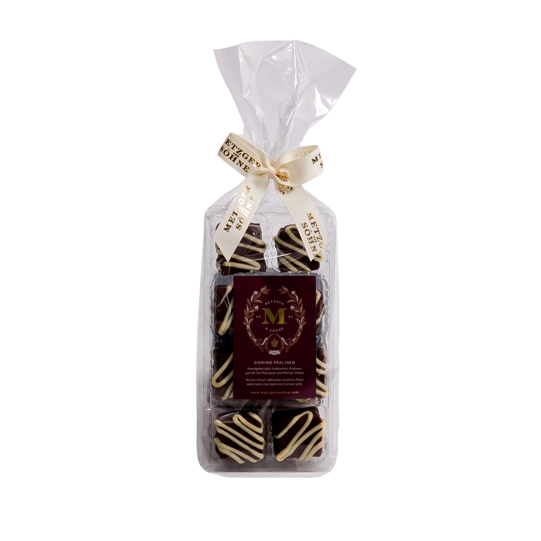 Handmade Lebkuchen chocolates filled with marzipan and currant jelly covered in dark chocolate couverture and decorated with white chocolate couverture.