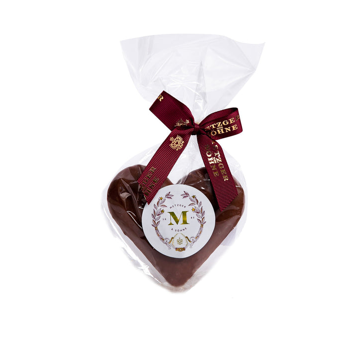 A play of bitter and sweet: a gingerbread heart filled with orange marmalade and covered in smooth milk chocolate.